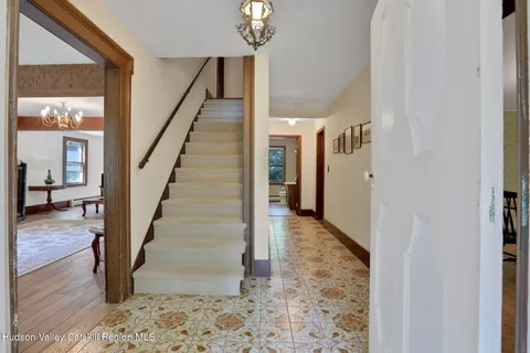a view of entryway and hall with wooden floor