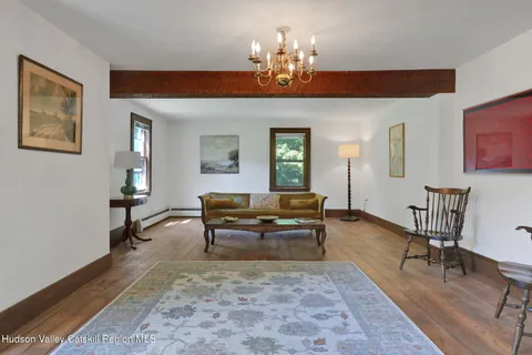 a living room with furniture a rug and a chandelier