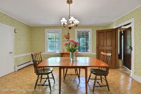 a view of a dining room with furniture wooden floor and chandelier
