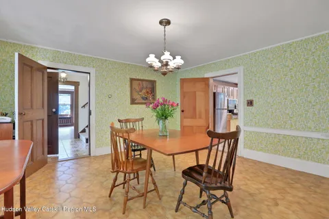 a view of a dining room with furniture and chandelier