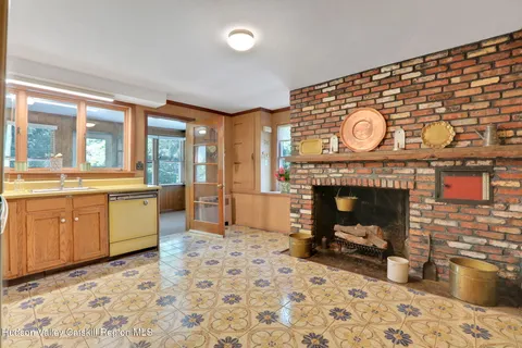 a living room with a fireplace and a large window