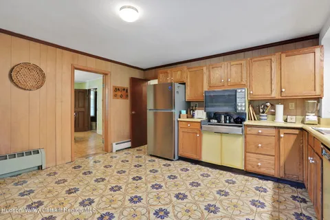 a kitchen with a refrigerator sink and cabinets