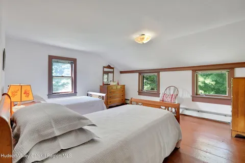 a bedroom with a bed and a large window