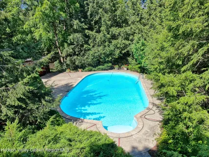 a view of a swimming pool with a yard
