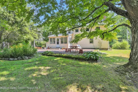 a view of a house with a backyard