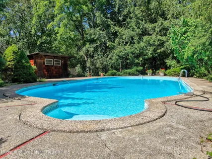 a view of a swimming pool with a yard