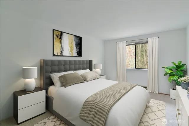 a bedroom with a bed lamp and a potted plant