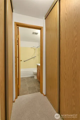 a bathroom with a granite countertop sink mirror toilet and bathtub