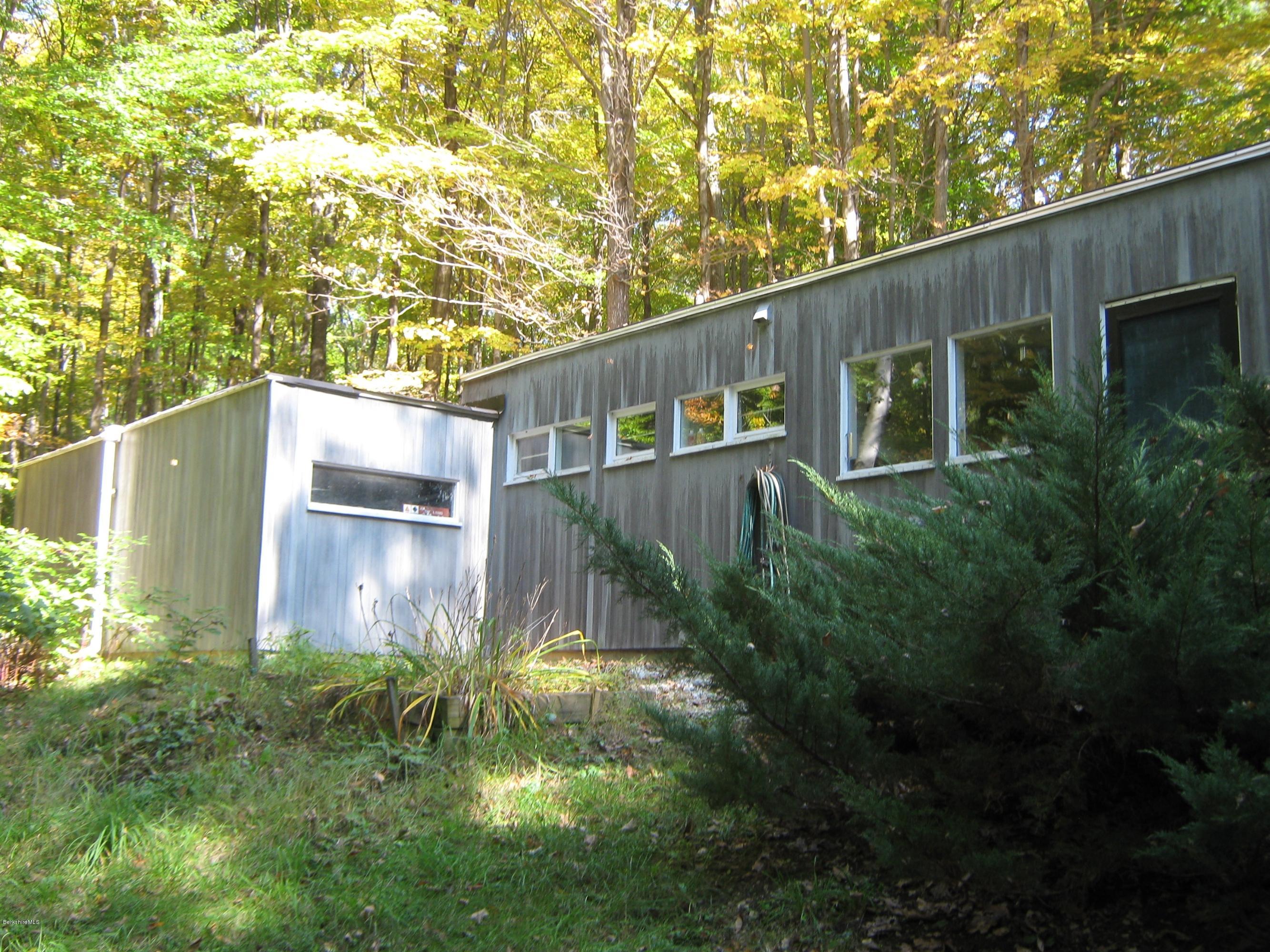 231 Summit Road Richmond, MA 01254 - Photo 12 of 69 a backyard of a house with plants and large trees with wooden fence