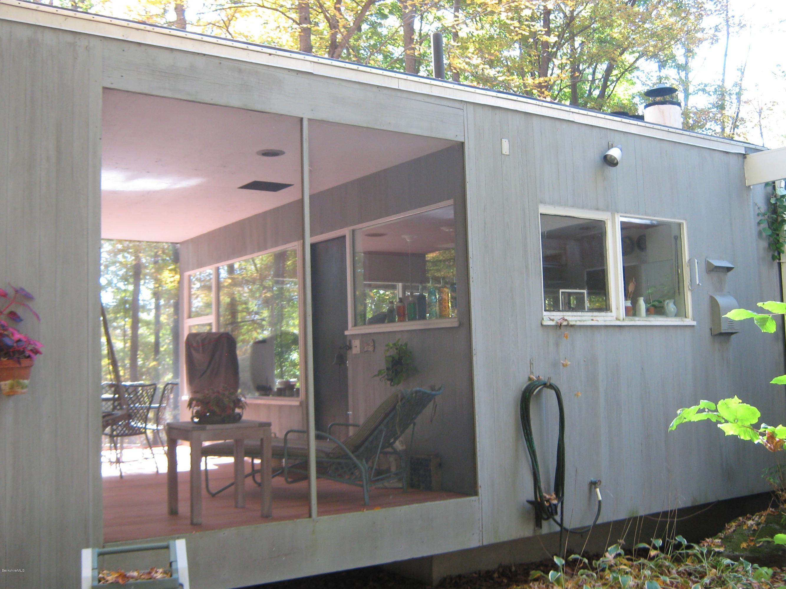 231 Summit Road Richmond, MA 01254 - Photo 22 of 69 a front view of a house with outdoor seating and plants