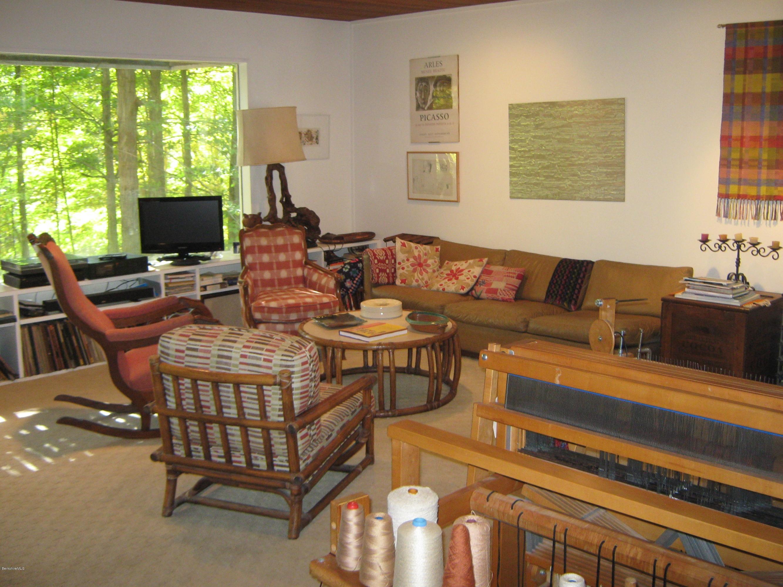 231 Summit Road Richmond, MA 01254 - Photo 35 of 69 a living room with furniture a flat screen tv and a large window