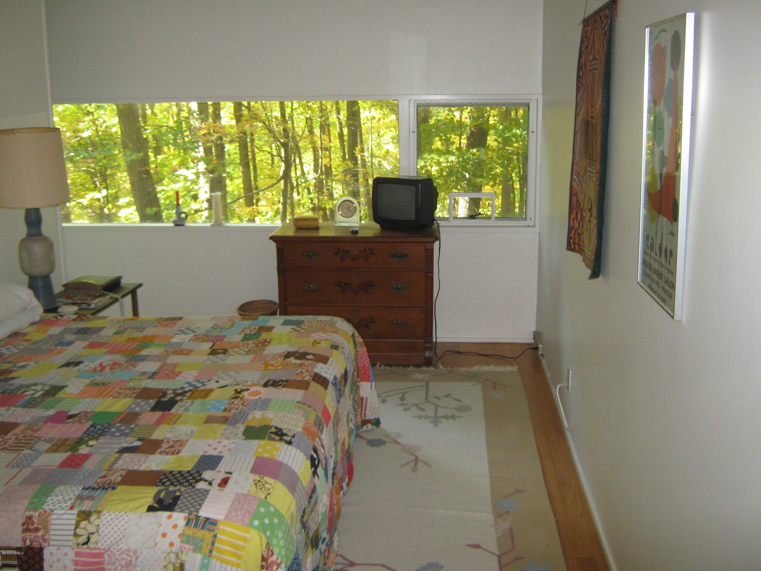 231 Summit Road Richmond, MA 01254 - Photo 38 of 69 a bed sitting in a bedroom next to a window