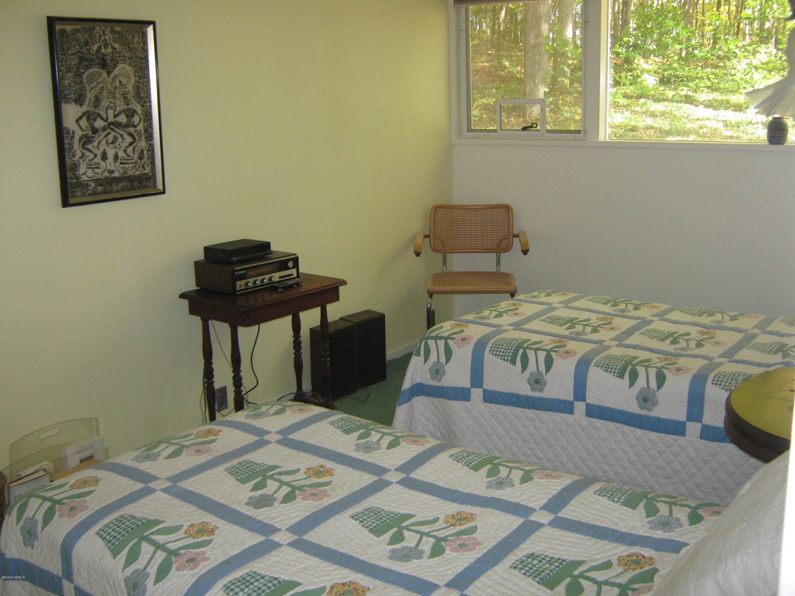 231 Summit Road Richmond, MA 01254 - Photo 53 of 69 a bed sitting in a bedroom next to a window