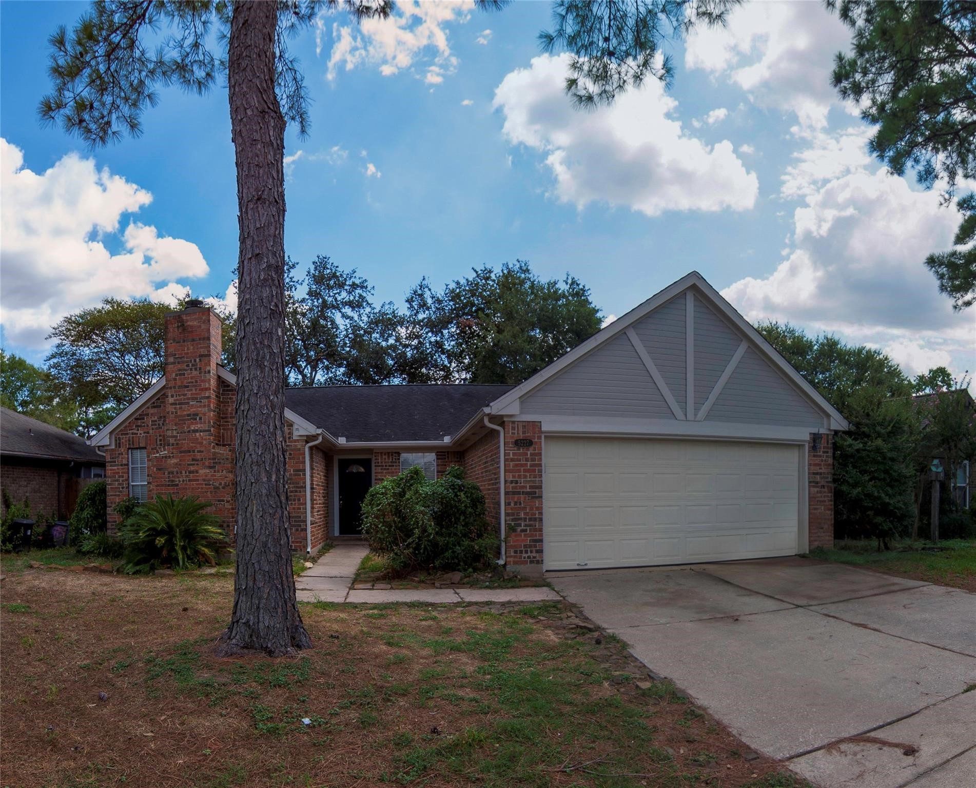 a view of a house with a yard and garage