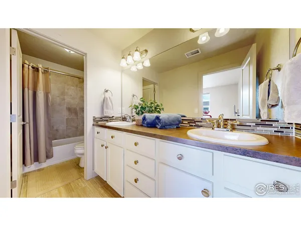 a bathroom with a sink and a shower curtain