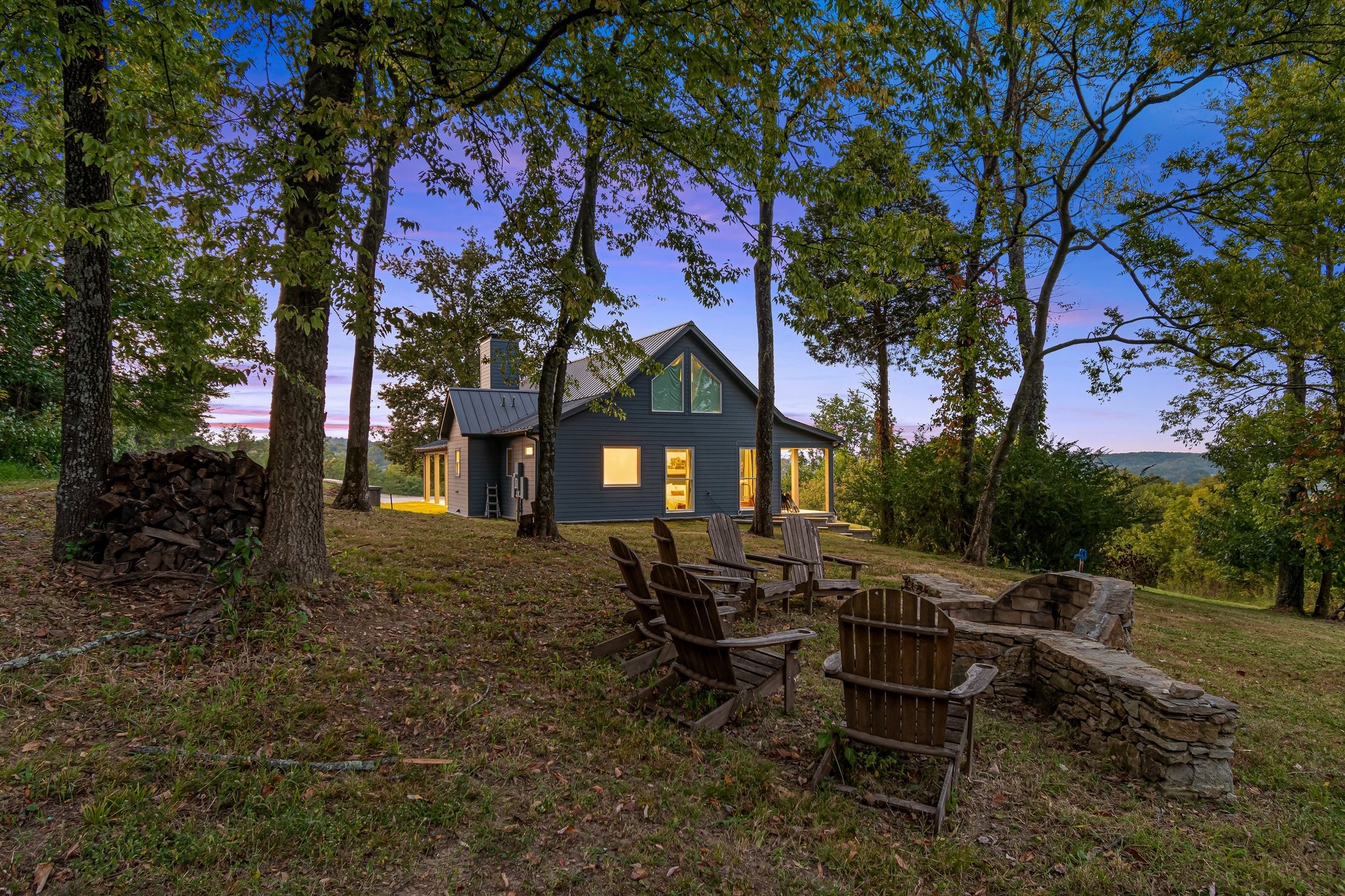 a house view with a sitting space fire pit and outdoor space