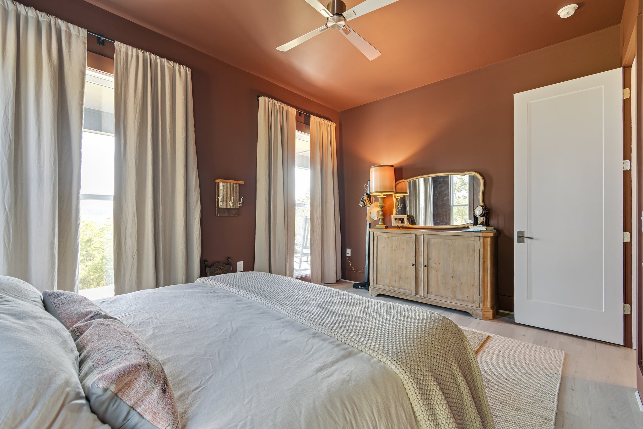 8740 Howell Road Mount Pleasant, TN 38474 - Photo 30 of 70 a bedroom with a large bed and a chandelier