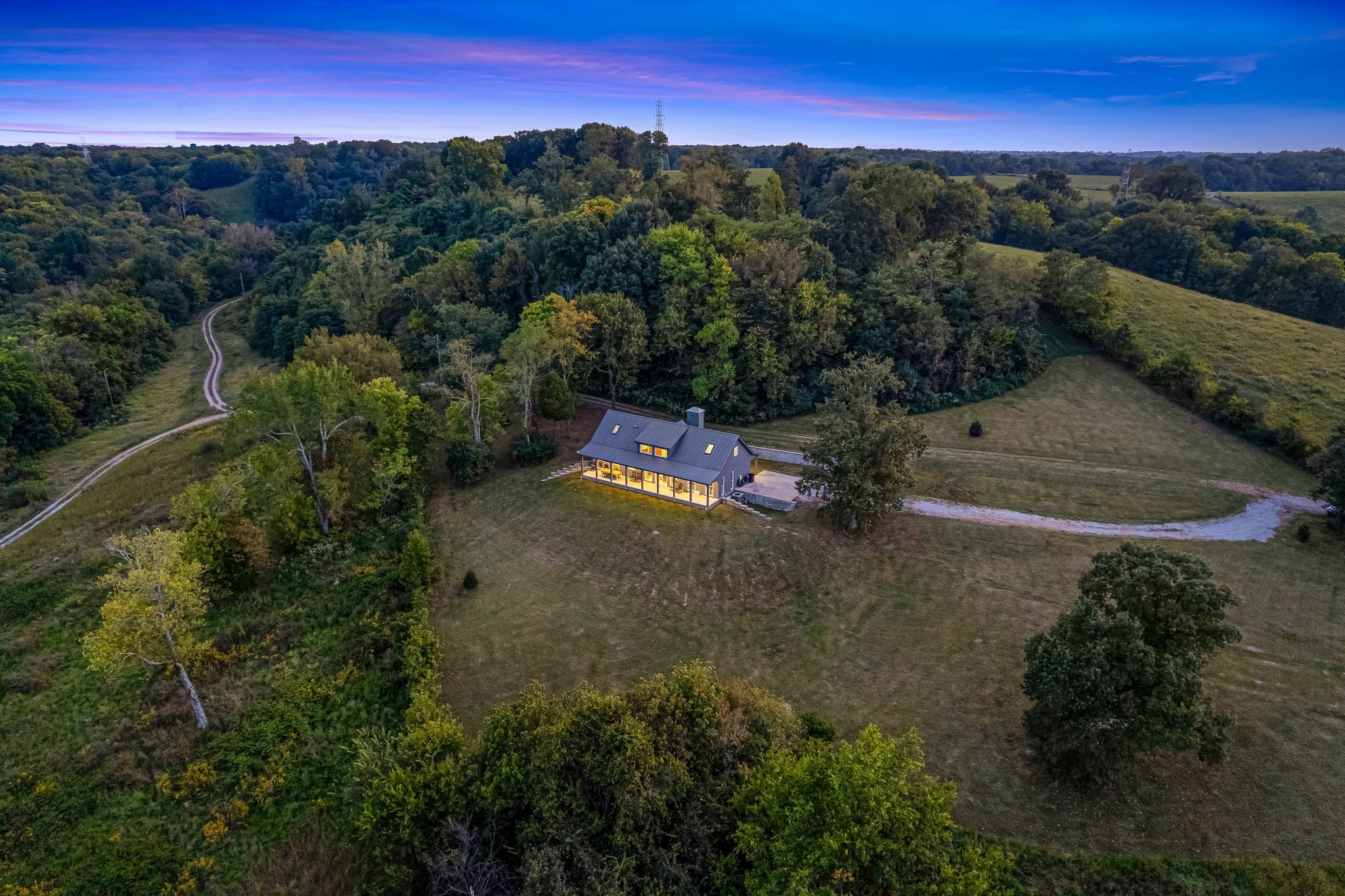8740 Howell Road Mount Pleasant, TN 38474 - Photo 4 of 70 an aerial view of residential houses with outdoor space and trees