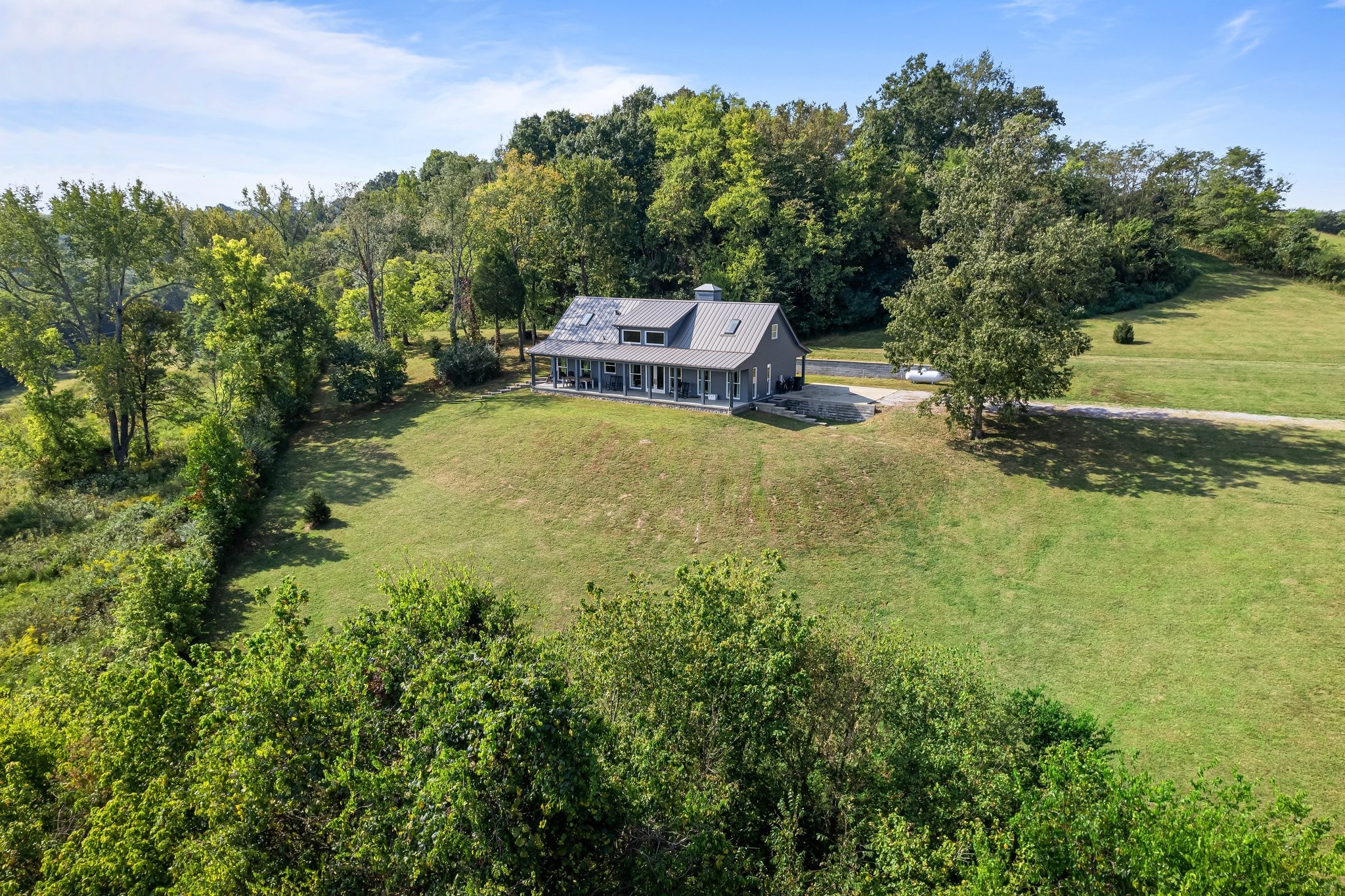 8740 Howell Road Mount Pleasant, TN 38474 - Photo 45 of 70 a backyard of a house with a yard and outdoor seating