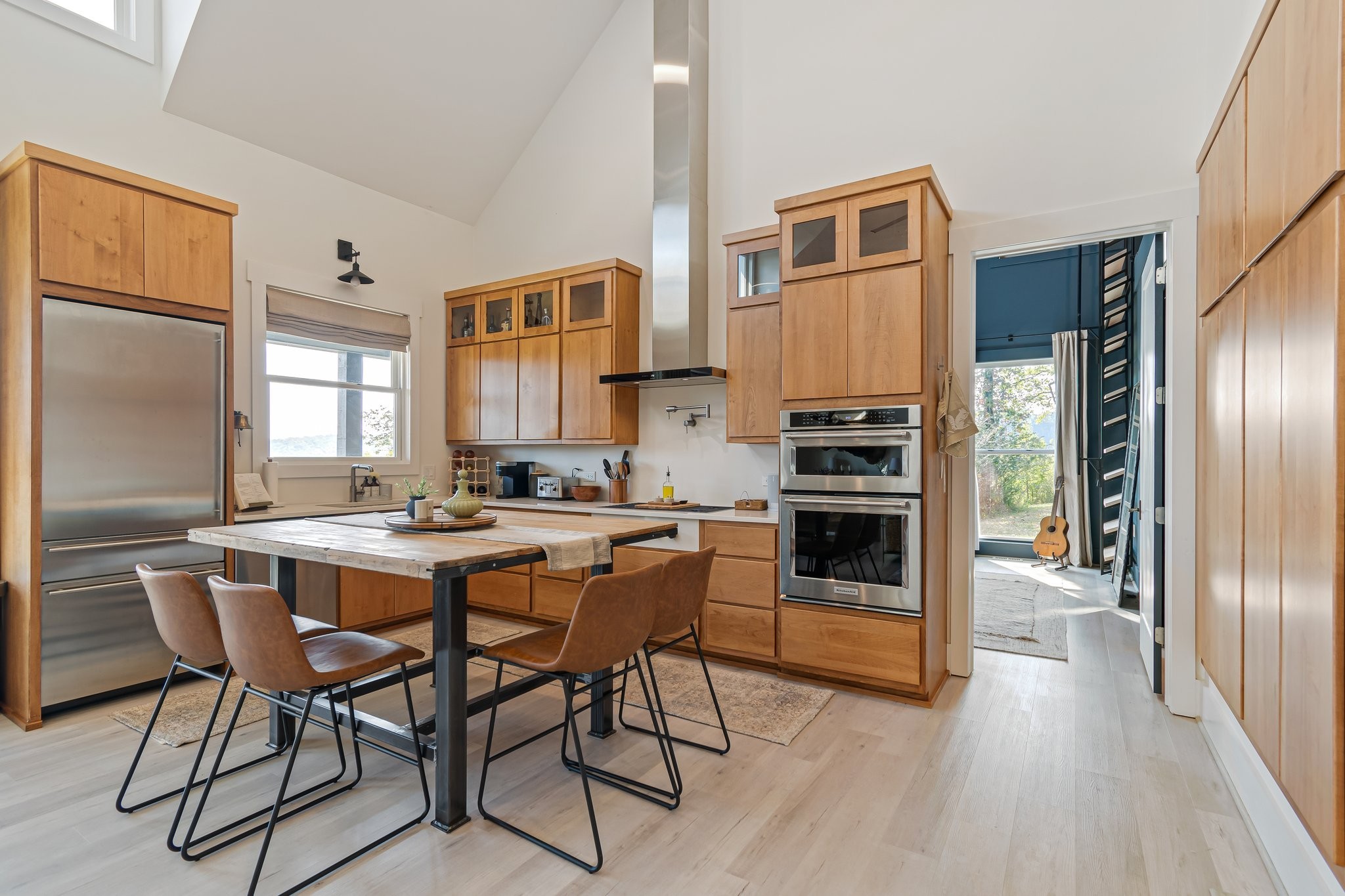 8740 Howell Road Mount Pleasant, TN 38474 - Photo 5 of 70 a kitchen with a table chairs refrigerator and cabinets