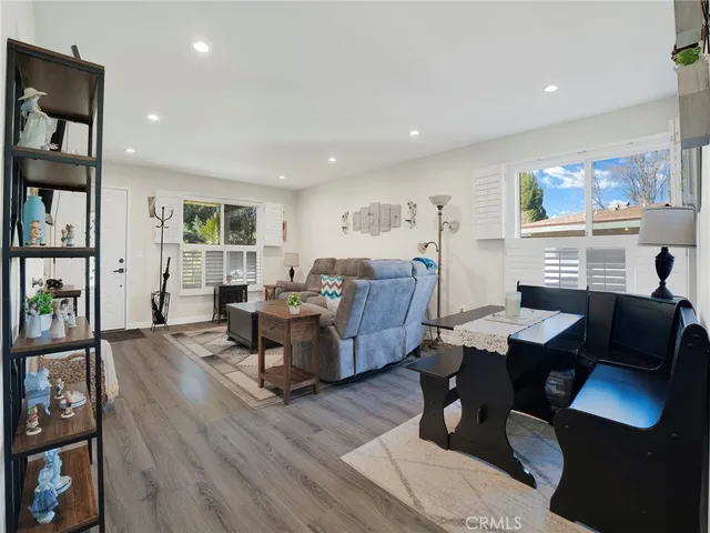 a living room with fireplace furniture and a wooden floor
