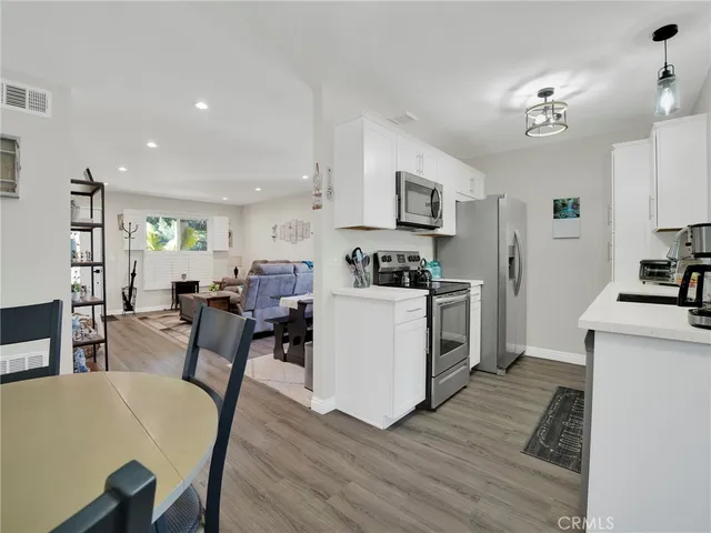 a view of kitchen with cabinets and wooden floor