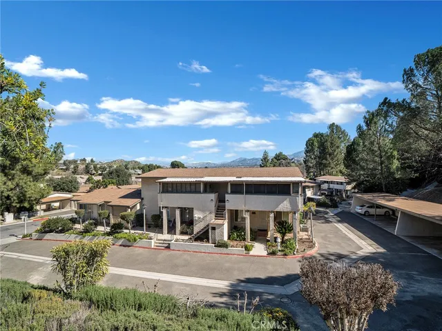 a view of a town with garage and large trees