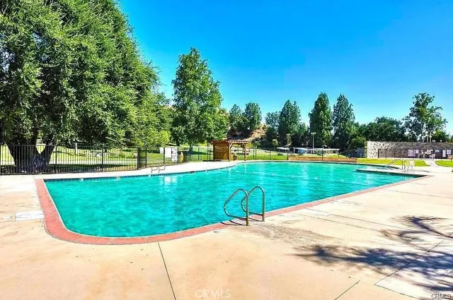 a view of a swimming pool with a yard