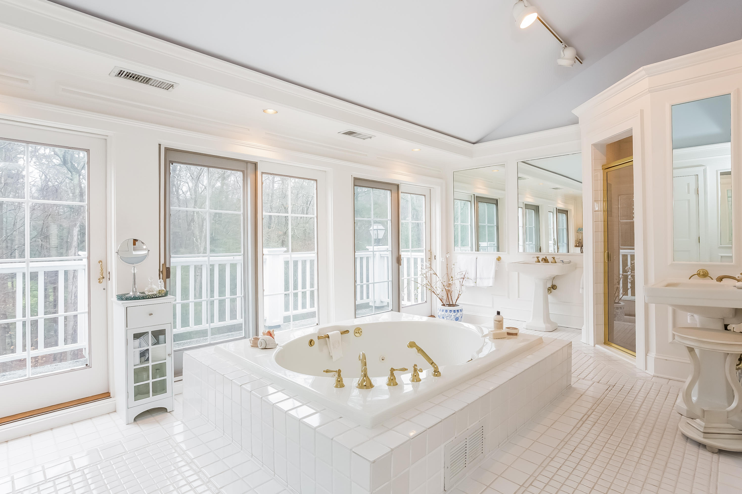 269 Valley Road New Canaan, CT 06840 - Photo 14 of 21 a white bath tub sitting in a spacious bathroom next to a window