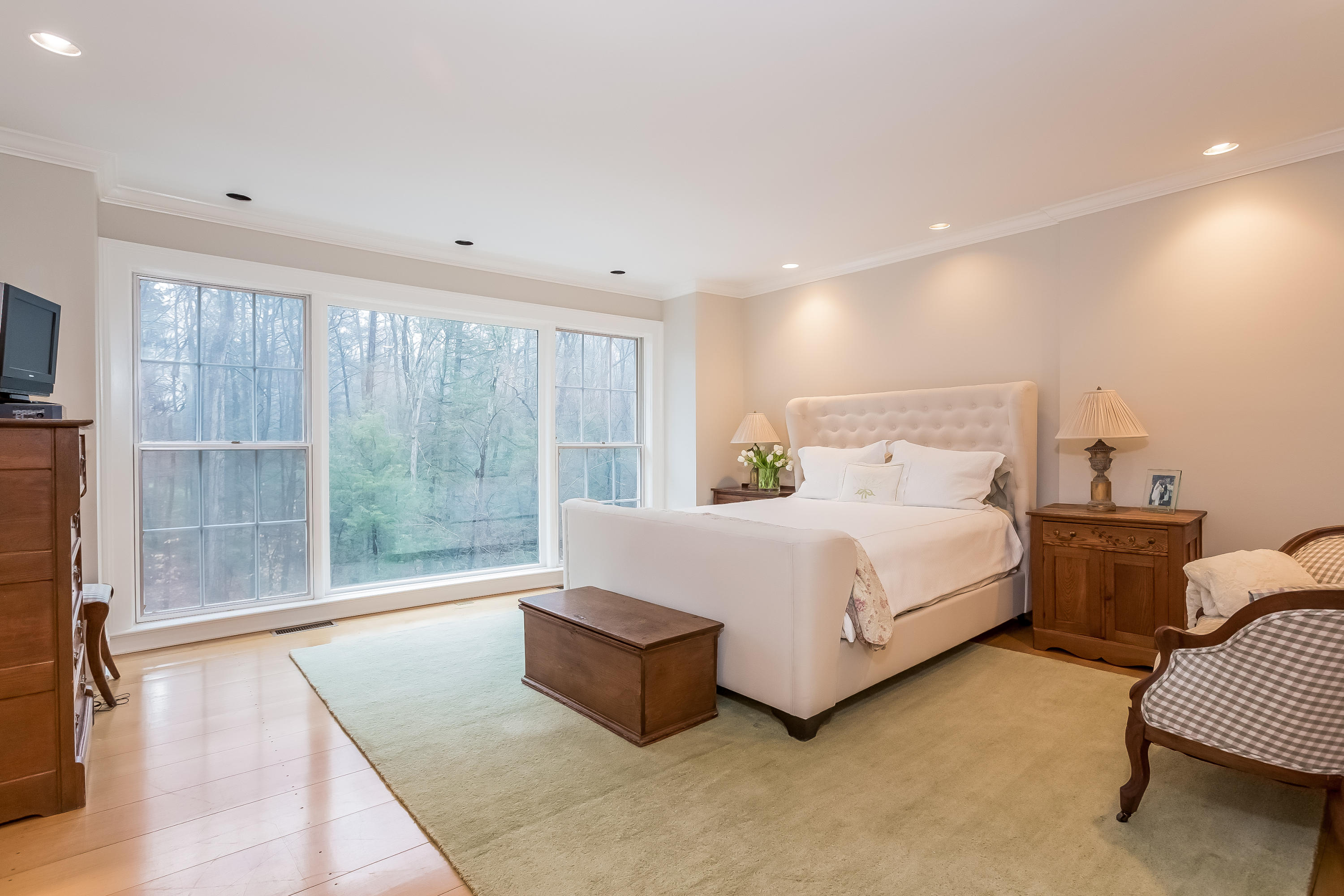 269 Valley Road New Canaan, CT 06840 - Photo 15 of 21 a large white bed sitting in a room next to a window
