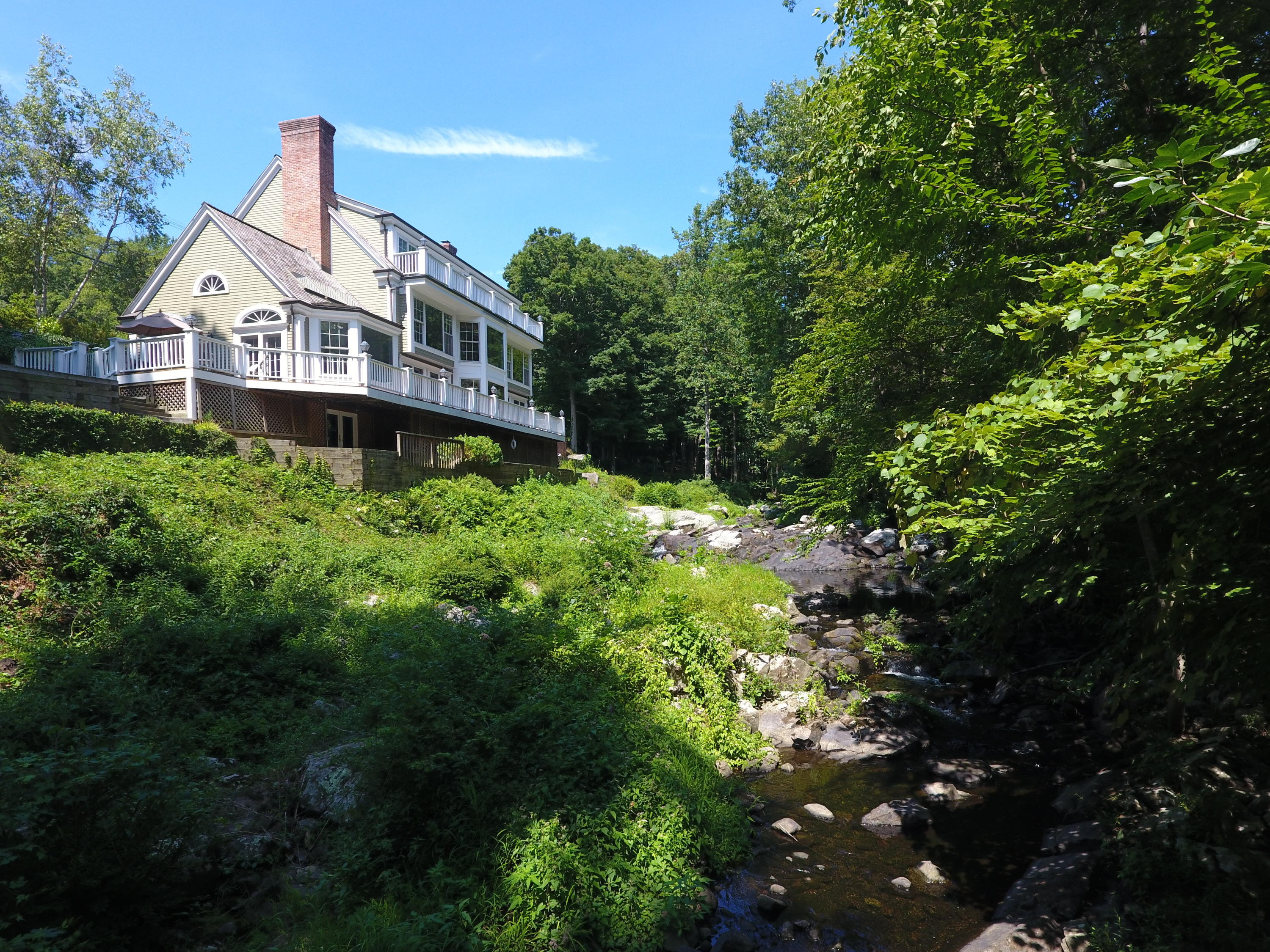 269 Valley Road New Canaan, CT 06840 - Photo 2 of 21 a front view of a house with a yard