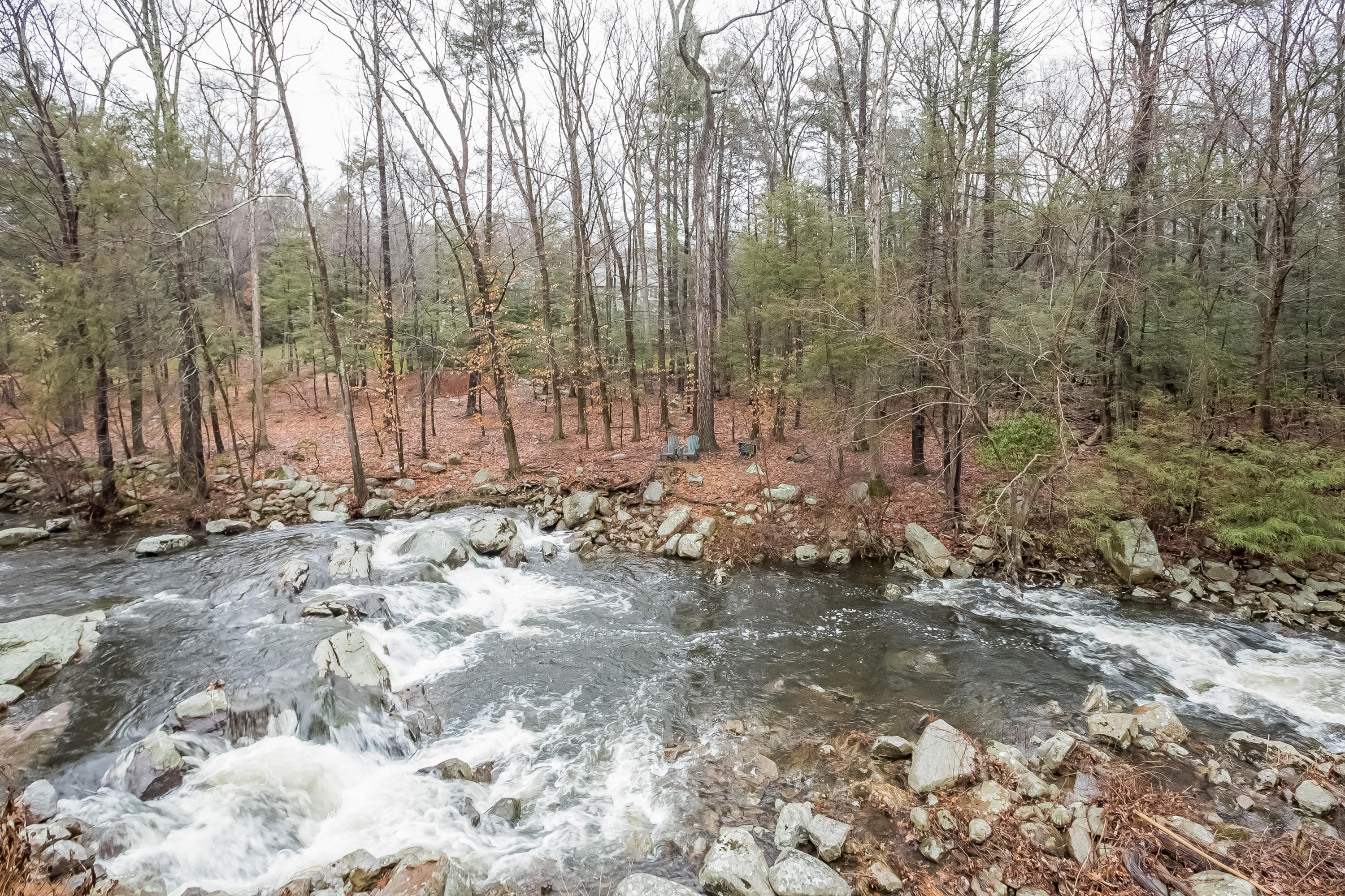 269 Valley Road New Canaan, CT 06840 - Photo 4 of 21 a view of a backyard with trees