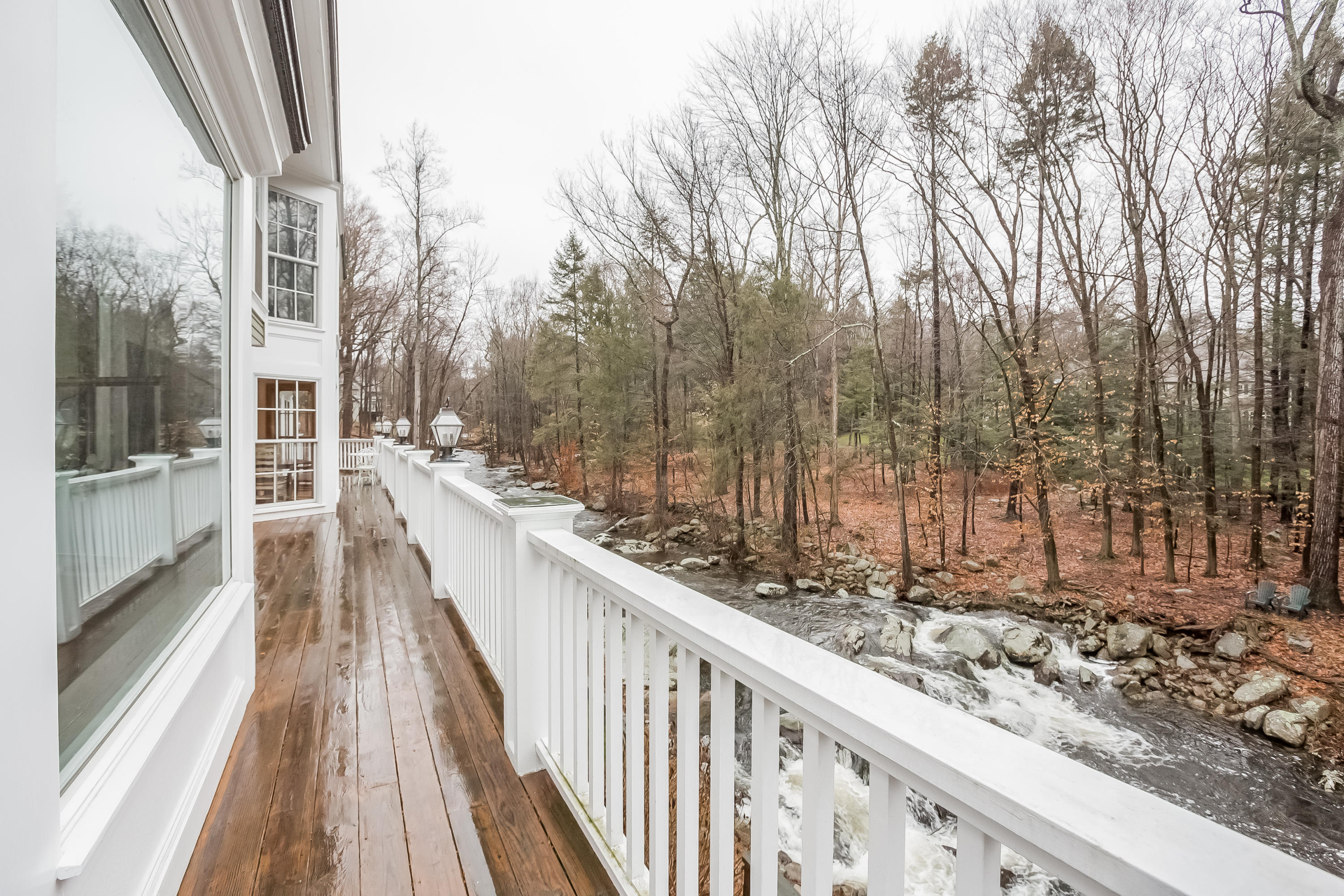 269 Valley Road New Canaan, CT 06840 - Photo 5 of 21 a view of a balcony with wooden floor and fence