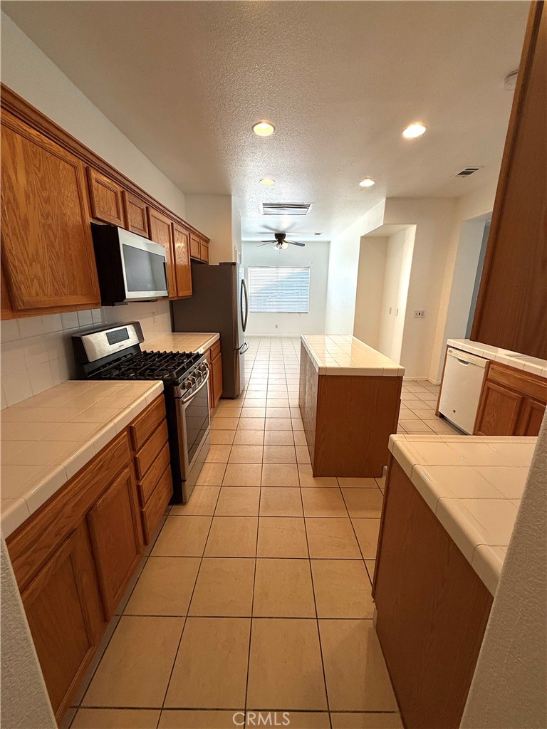 1335 Torrey Pines Court Atwater, CA 95301 - Photo 4 of 28 a kitchen with a sink a stove and a microwave