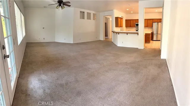 a view of a kitchen with a refrigerator and a sink