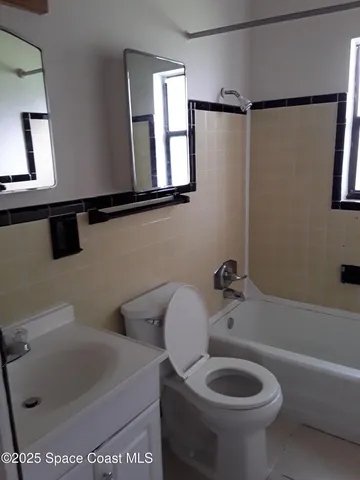 a bathroom with a toilet a sink and bathtub