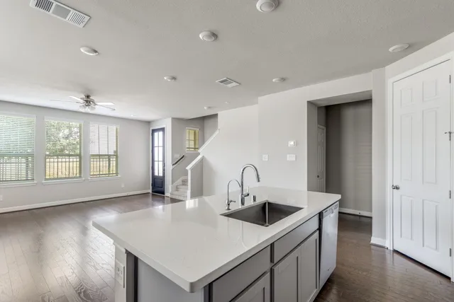 a kitchen with a sink a counter top space and cabinets
