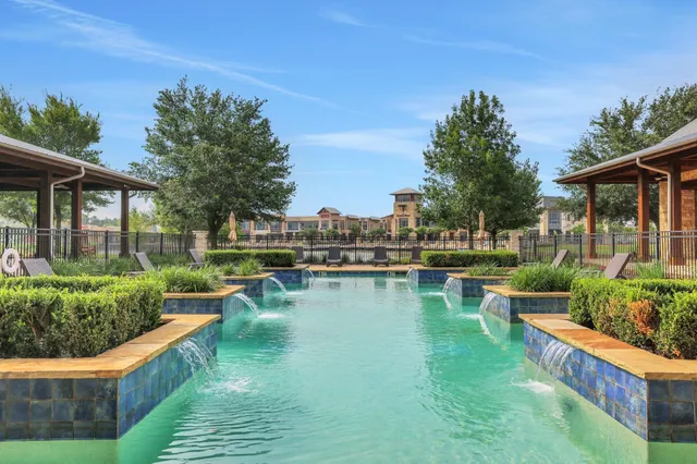 a view of a house with swimming pool and sitting area