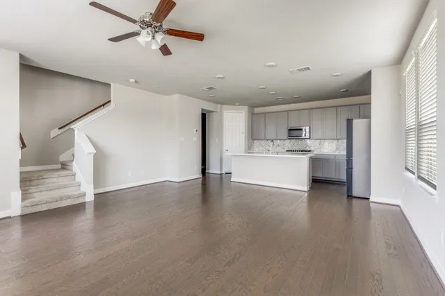 a view of a livingroom with hardwood floor and a ceiling fan