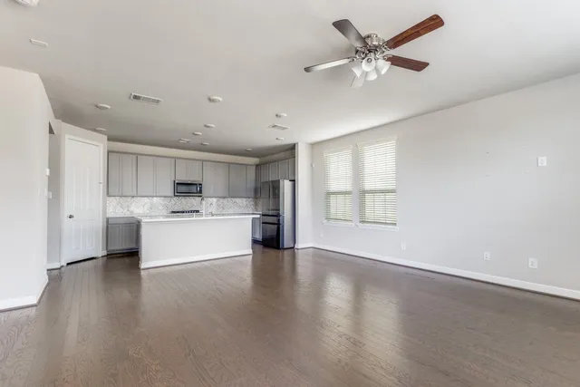 a view of kitchen with stainless steel appliances refrigerator oven and cabinets