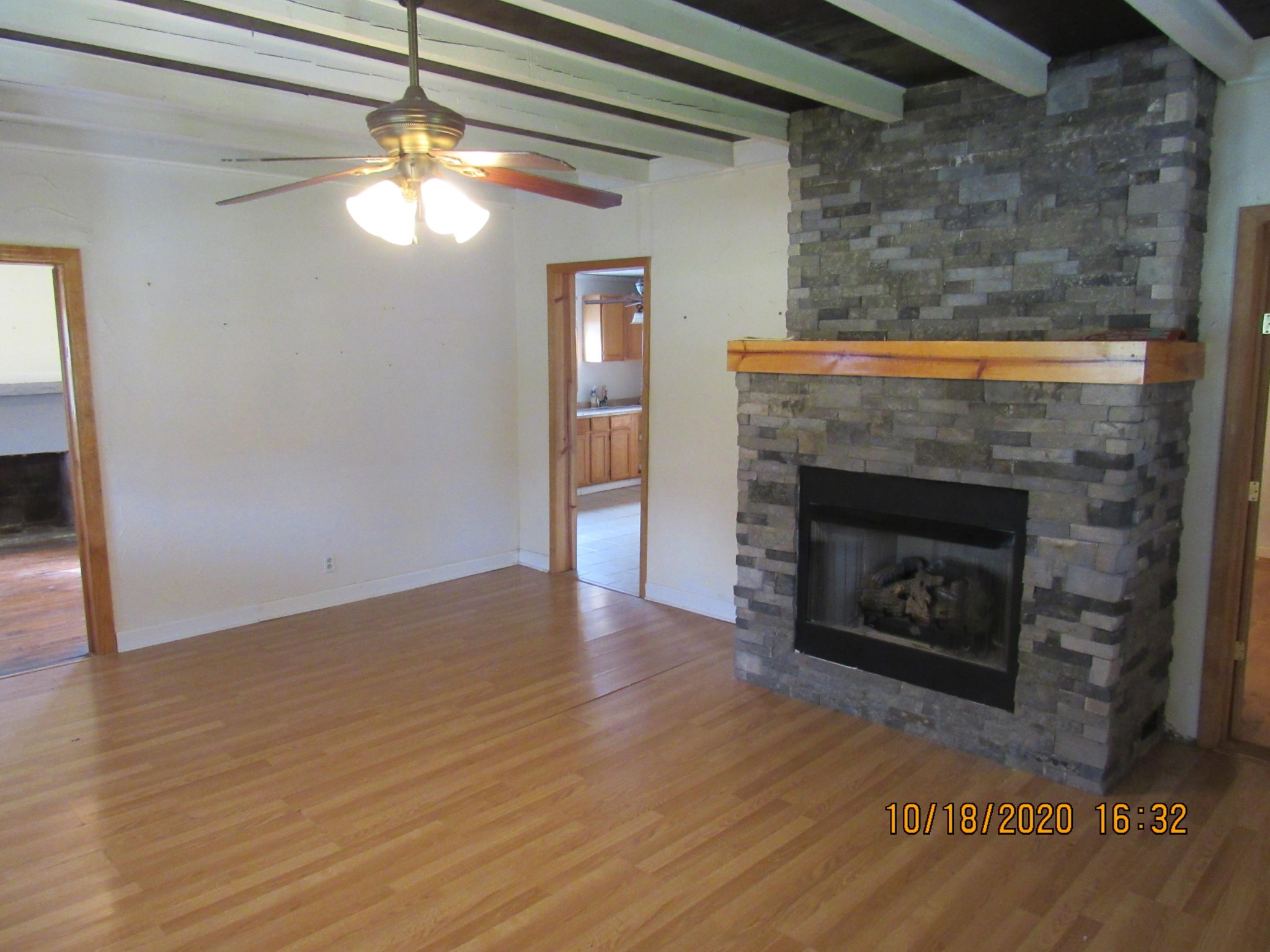 110 Spring Street Lancing, TN 37770 - Photo 8 of 16 a view of an empty room with wooden floor fireplace and a window
