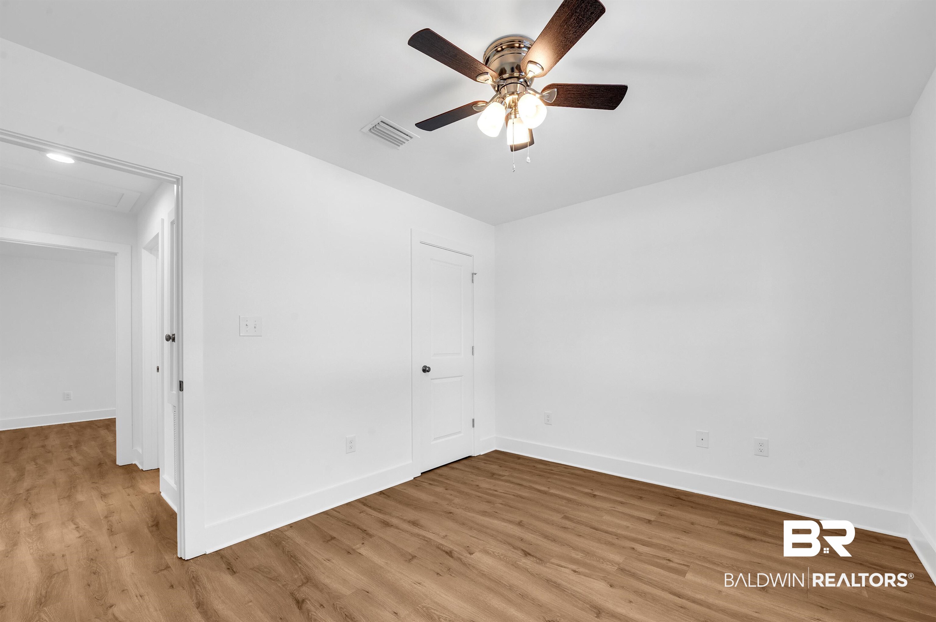 22045 8th Street Silverhill, AL 36576 - Photo 23 of 39 Primary bedroom with light wood finished floors, baseboards, and ceiling fan