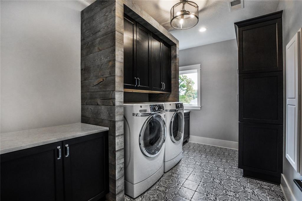 502 Ridge Court Wexford, PA 15090 - Photo 22 of 25 SECOND FLOOR OVERSIZED LAUNDRY ROOM WITH PLENTY OF CABINETS, MODERN TILE FLOORING, FOLDING COUNTER, SINK AND LOTS OF STORAGE!