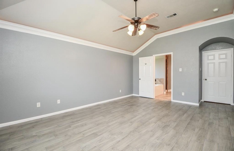 8515 Split Branch Lane Houston, TX 77095 - Photo 12 of 31 a view of an empty room with a chandelier fan