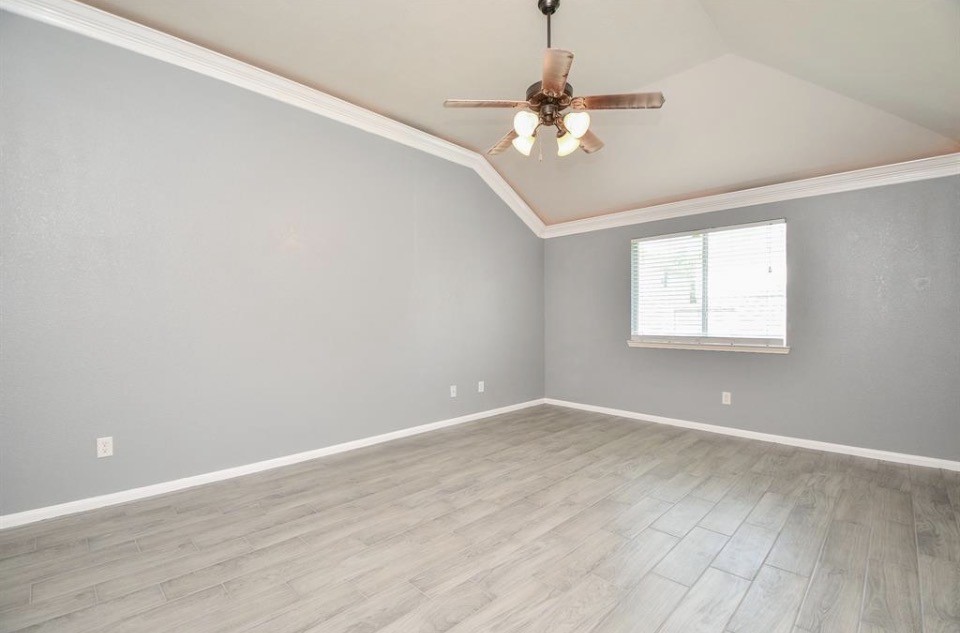 8515 Split Branch Lane Houston, TX 77095 - Photo 13 of 31 a view of an empty room with wooden floor and a window