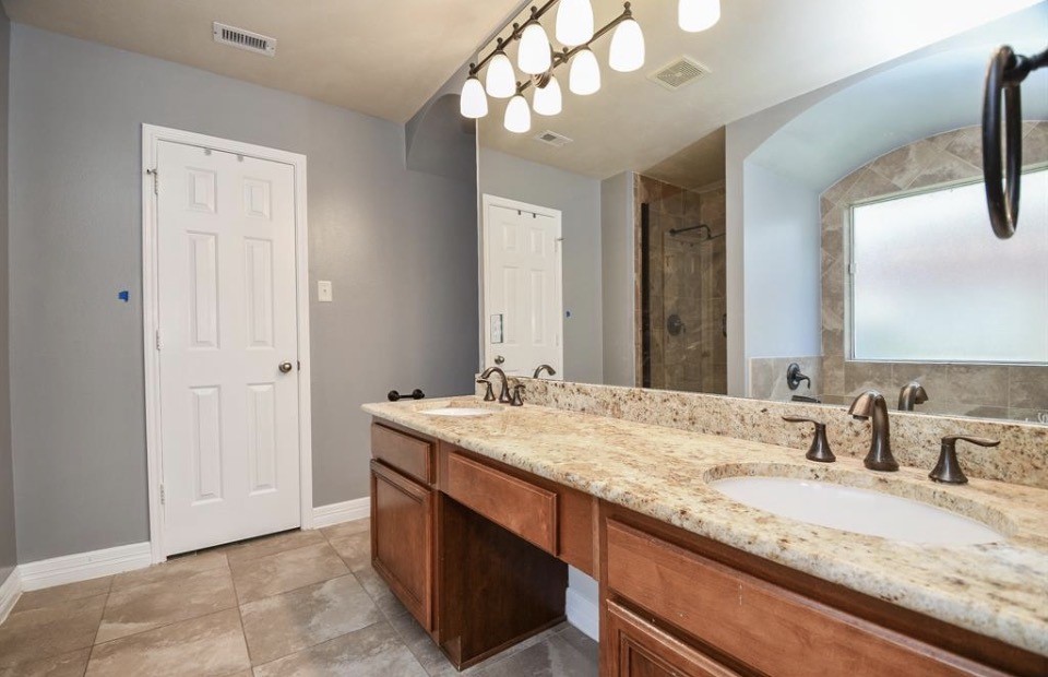 8515 Split Branch Lane Houston, TX 77095 - Photo 16 of 31 a bathroom with a granite countertop sink and a mirror
