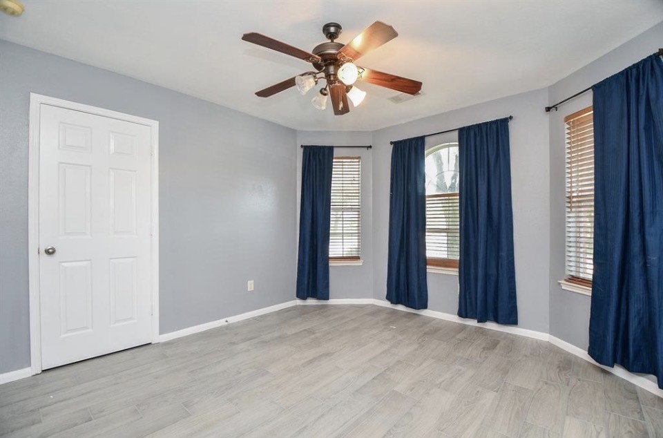 8515 Split Branch Lane Houston, TX 77095 - Photo 19 of 31 a view of a room with a ceiling fan and a window