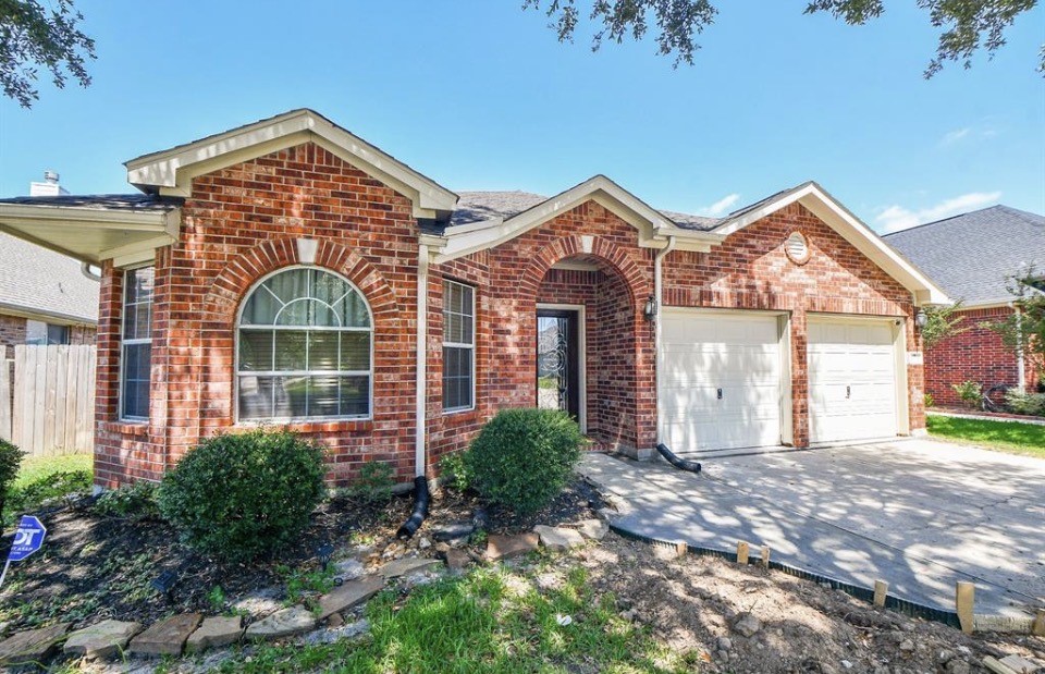 8515 Split Branch Lane Houston, TX 77095 - Photo 2 of 31 a front view of a house with garden