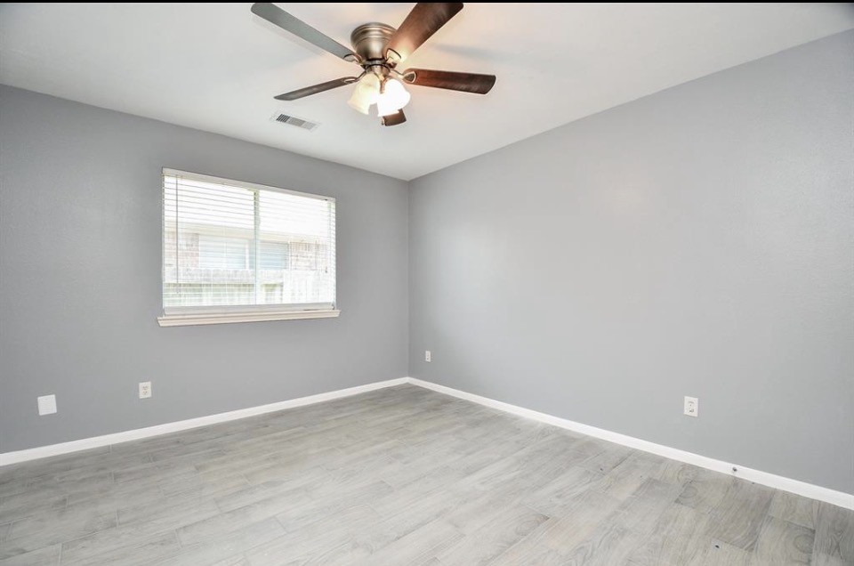 8515 Split Branch Lane Houston, TX 77095 - Photo 22 of 31 an empty room with a window and a fan