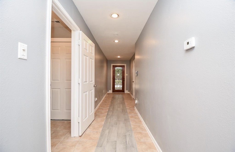 8515 Split Branch Lane Houston, TX 77095 - Photo 4 of 31 a view of a hallway with wooden floor and staircase